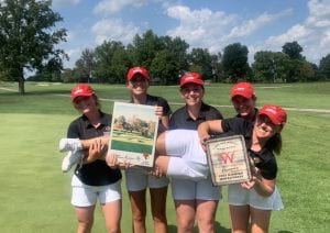 Nerea poses with her golf teammates on the course.